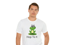 Load image into Gallery viewer, white t-shirt with a green sitting frog and the caption 'hop to it'