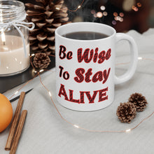 Load image into Gallery viewer, 11 oz white ceramic mug with caption 'be wise to stay alive' in red letters
