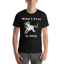 Load image into Gallery viewer, black t-shirt with a unicorn and the caption wild & free in 2023