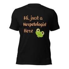 Load image into Gallery viewer, t-shirt with the caption "hi, just a herpetologist here" and a peeping frog