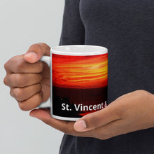 Load image into Gallery viewer, 11oz ceramic mug featuring a photograph of a vibrant sunset in St. Vincent and the Grenadines