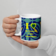 Load image into Gallery viewer, 11oz ceramic mug with I love St. Vincent and the Grenadines written in yellow and a national colored heart all on a blue and yellow swirly lined background