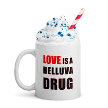Load image into Gallery viewer, 11oz ceramic mug with the caption 'love is a helluva drug'