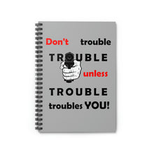Load image into Gallery viewer, grey cover spiral notebook with the caption 'don't trouble trouble unless trouble troubles you' and a hand pointing a pistol