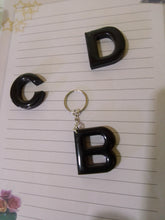 Load image into Gallery viewer, solid black volcanic ash and resin letter keyrings