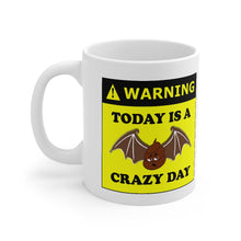 Load image into Gallery viewer, 11oz white ceramic mug with the caption 'Warning today is a bat shit crazy day' with 'bat shit' illustrated as a poop with bat wings.