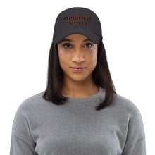 Load image into Gallery viewer, Dark grey dad hat with 'original vincy' written in black and red letters.