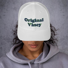 Load image into Gallery viewer, White trucker cap with 'original vincy' written in camouflage green letters.
