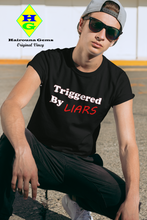 Load image into Gallery viewer, model wearing a black t-shirt with caption 'triggered by liars' in black and red lettering