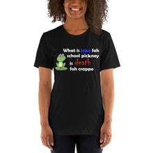 Load image into Gallery viewer, model wearing a black t-shirt with a picture of a frog stating 'what is joke foh school pickney is death foh crappo'.