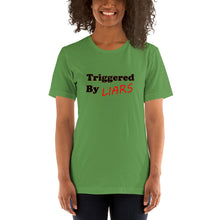 Load image into Gallery viewer, leaf-green t-shirt with caption 'triggered by liars' in black and red lettering