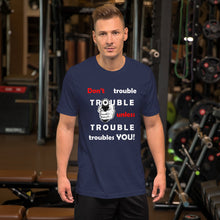 Load image into Gallery viewer, Navy t-shirt sporting the motto 'don't trouble trouble unless trouble troubles you' in black and red letters and a hand holding a gun.