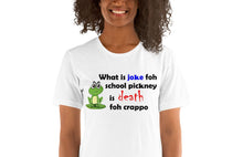 Load image into Gallery viewer, model wearing a white t-shirt with a picture of a frog stating 'what is joke foh school pickney is death foh crappo'.