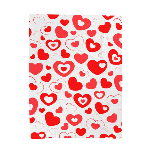 rectangular, white plush blanket with a red and white hearts design