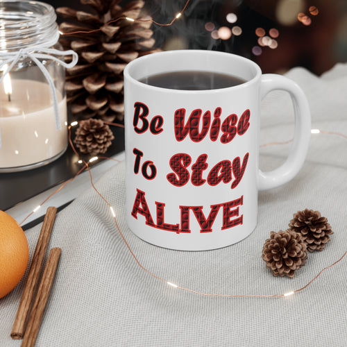 11 oz white ceramic mug with caption 'be wise to stay alive' in red letters