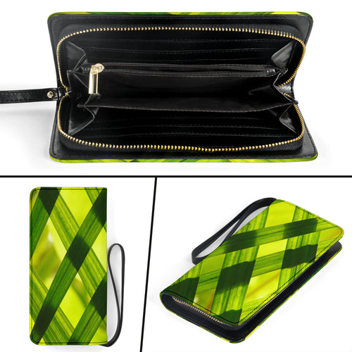 green clutch purse with many interior pockets and a bamboo grass leaf design