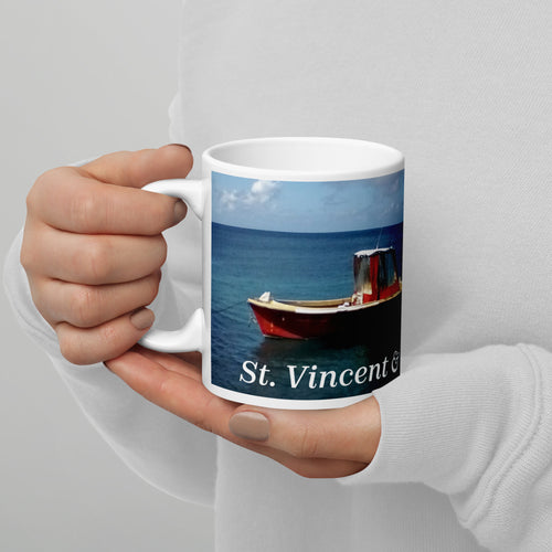 11oz ceramic coffee mug picturing two small boats bobbing in the water at a beach in St. Vincent and the Grenadines.