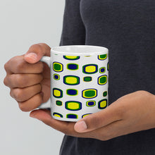 Load image into Gallery viewer, 11oz ceramic mug with a design of blue, yellow and green cubes  matching St. Vincent and the Grenadines&#39; national colors
