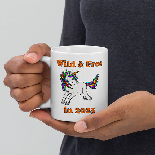 11oz ceramic mug with a unicorn and the caption 'wild and free in 2023'