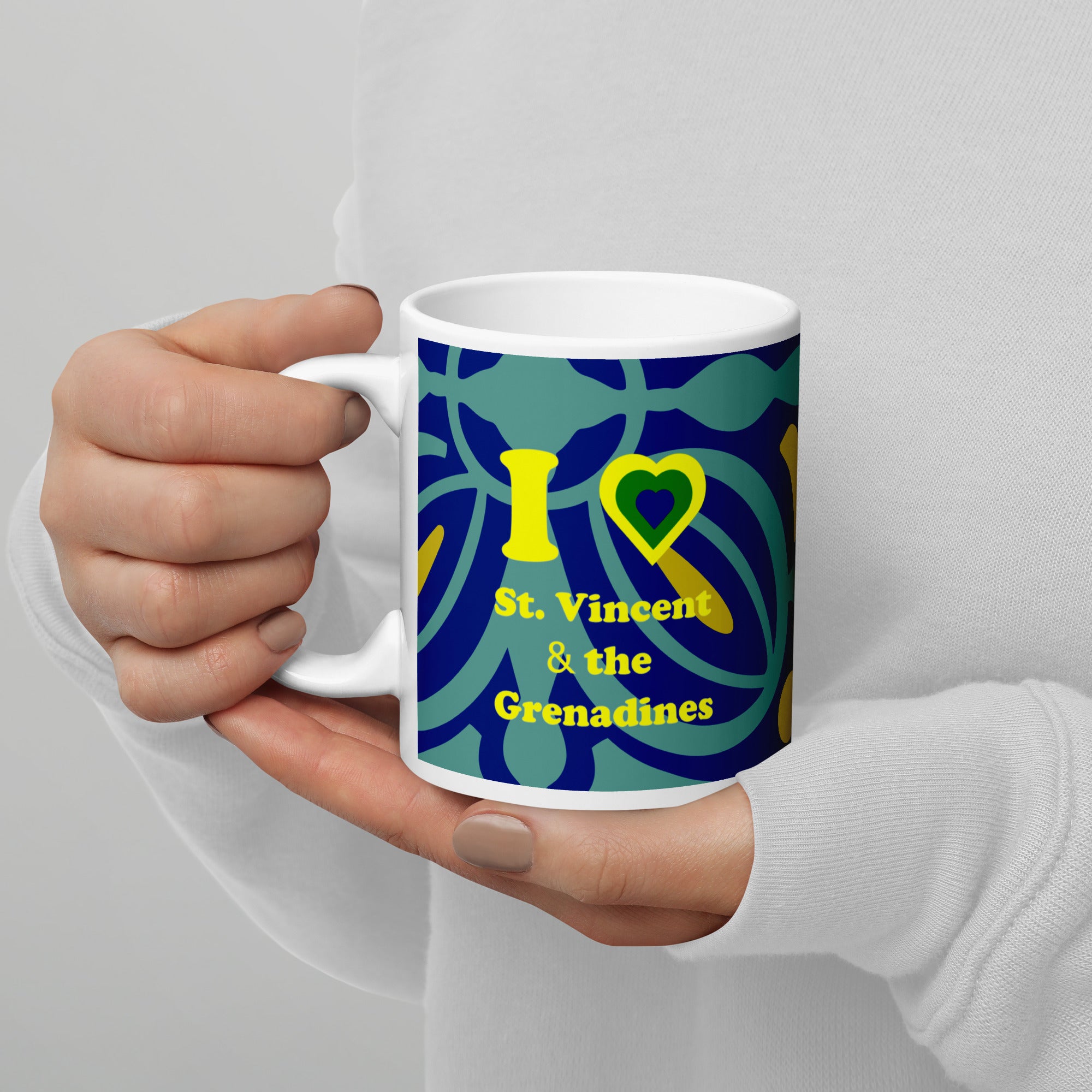 11oz ceramic mug with I love St. Vincent and the Grenadines written in yellow and a national colored heart all on a blue and yellow swirly lined background