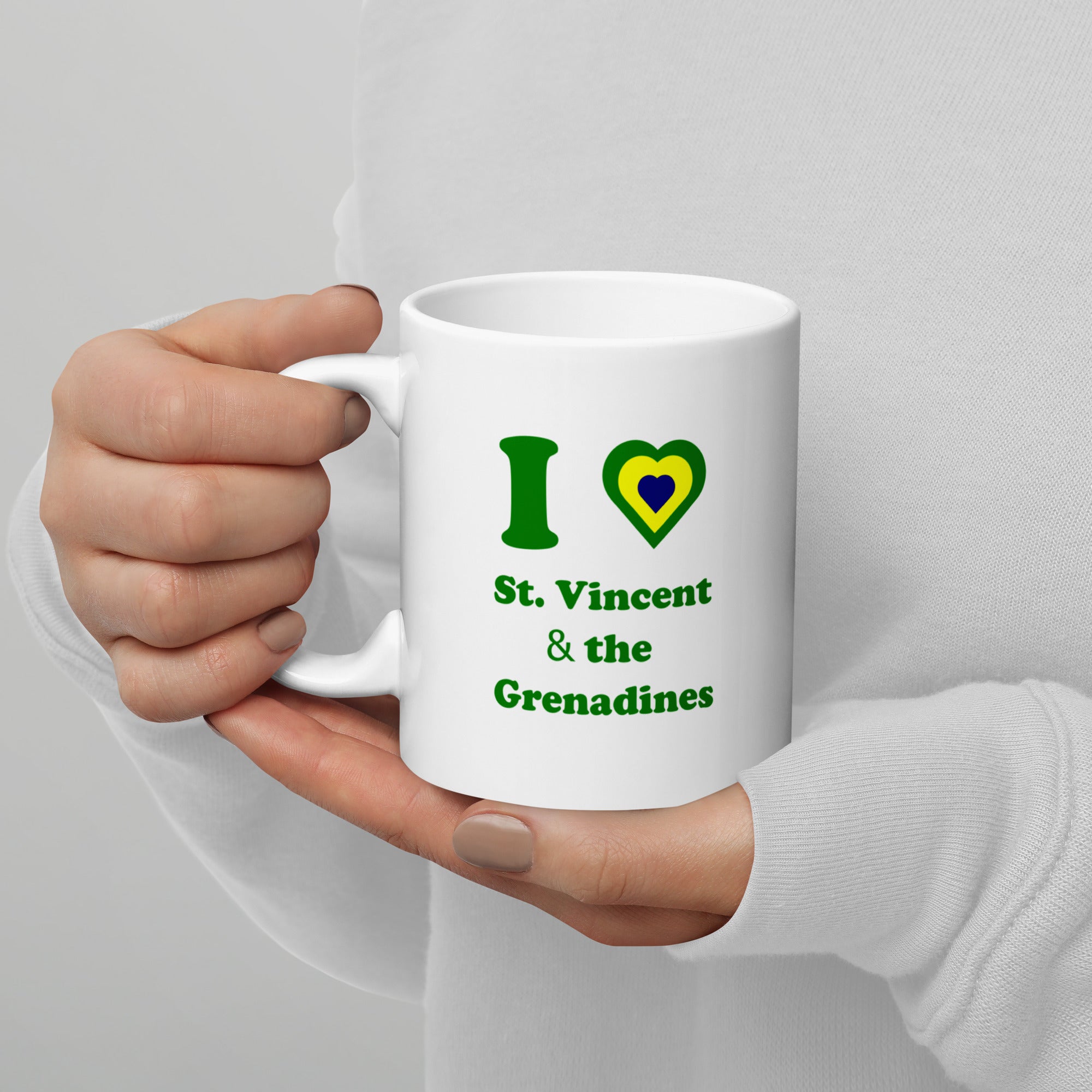 white 11oz ceramic mug with I () St. Vincent and the Grenadines written  in green and a national colored heart