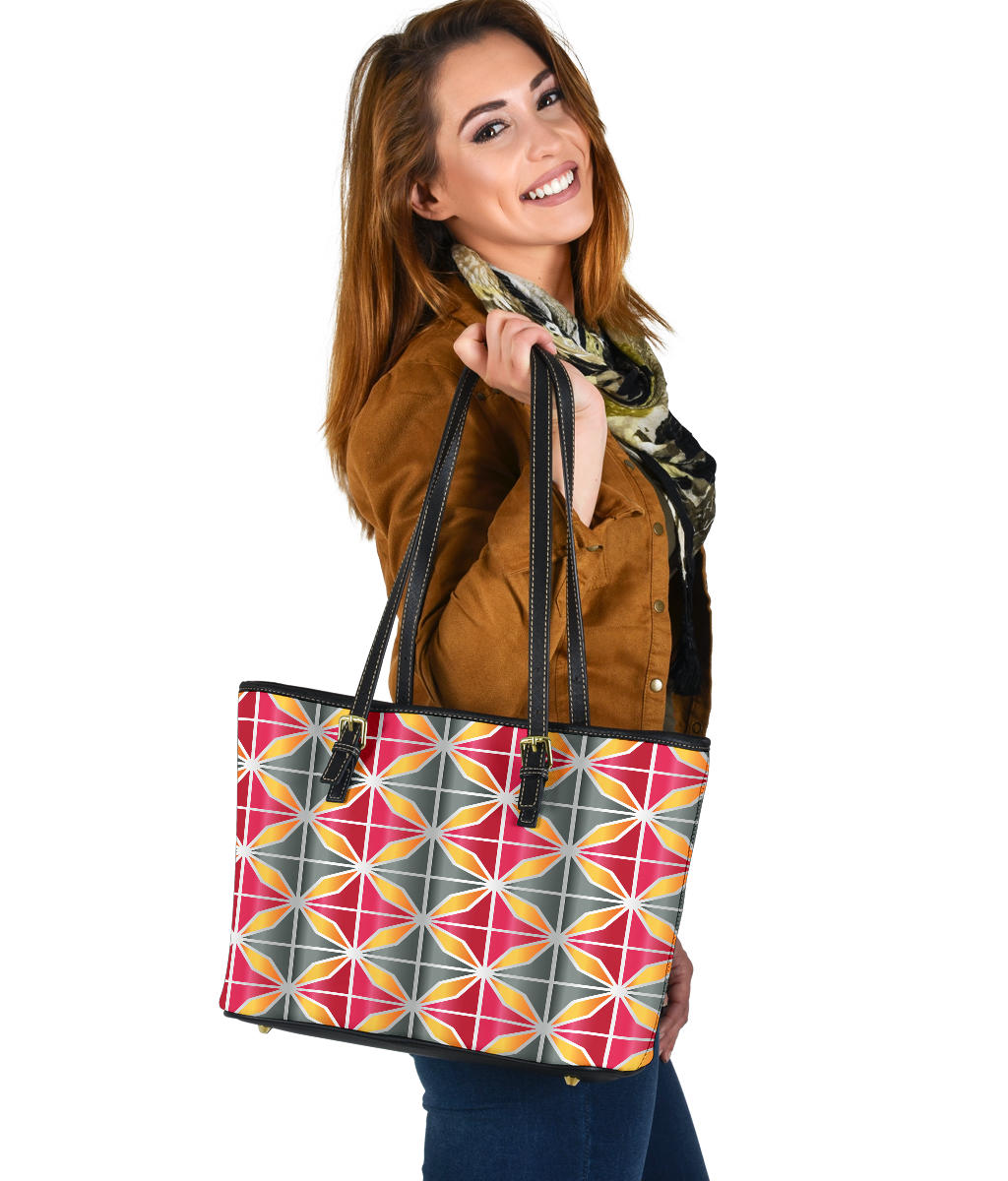 small leather tote bag with a gray, pink and orange geometric design