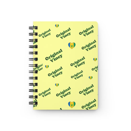 Yellow spiral notebook/journal with 'original vincy' written in camouflage green with hearts containing the St. Vincent and the Grenadines flag.