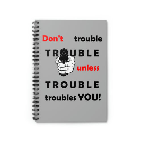 grey cover spiral notebook with the caption 'don't trouble trouble unless trouble troubles you' and a hand pointing a pistol