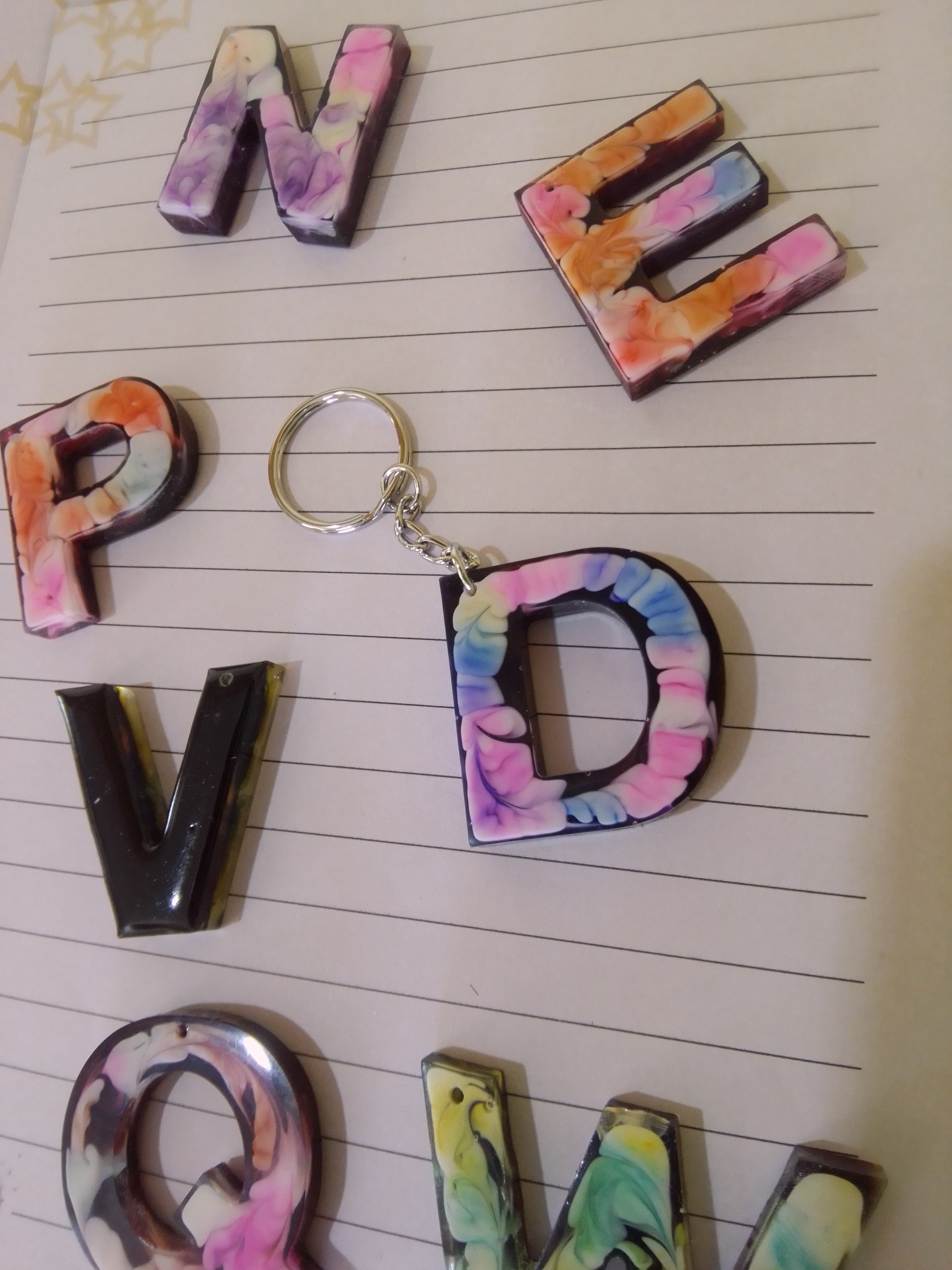 volcanic ash and resin letter keyring decorated with alcohol ink