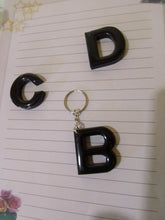 Load image into Gallery viewer, solid black volcanic ash and resin letter keyrings
