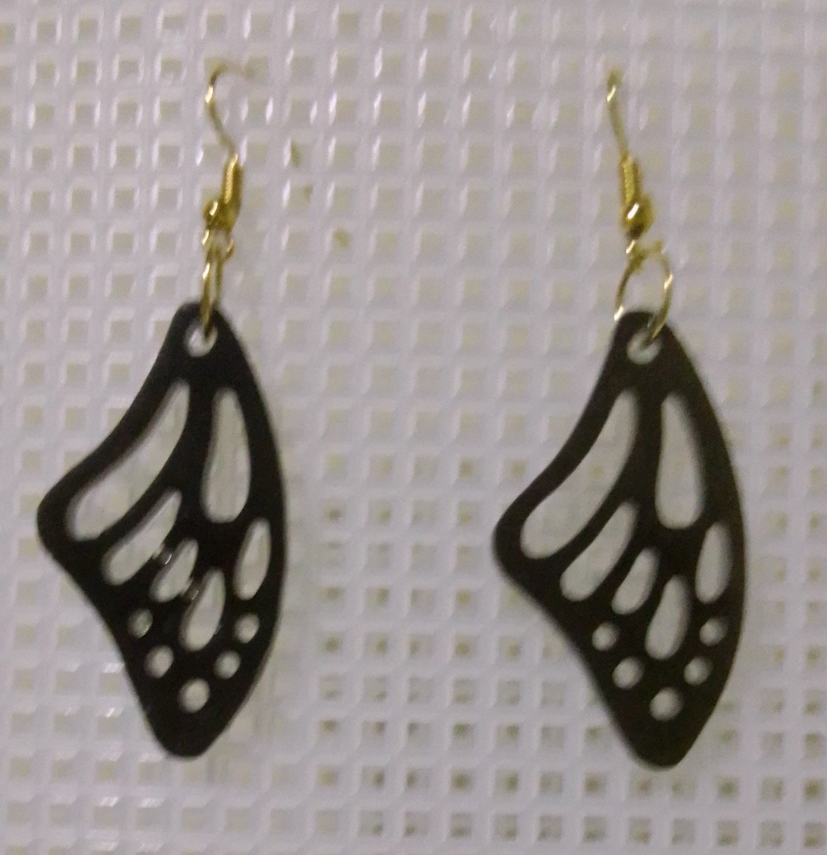 volcanic ash and epoxy resin earrings shaped like a butterfly wing