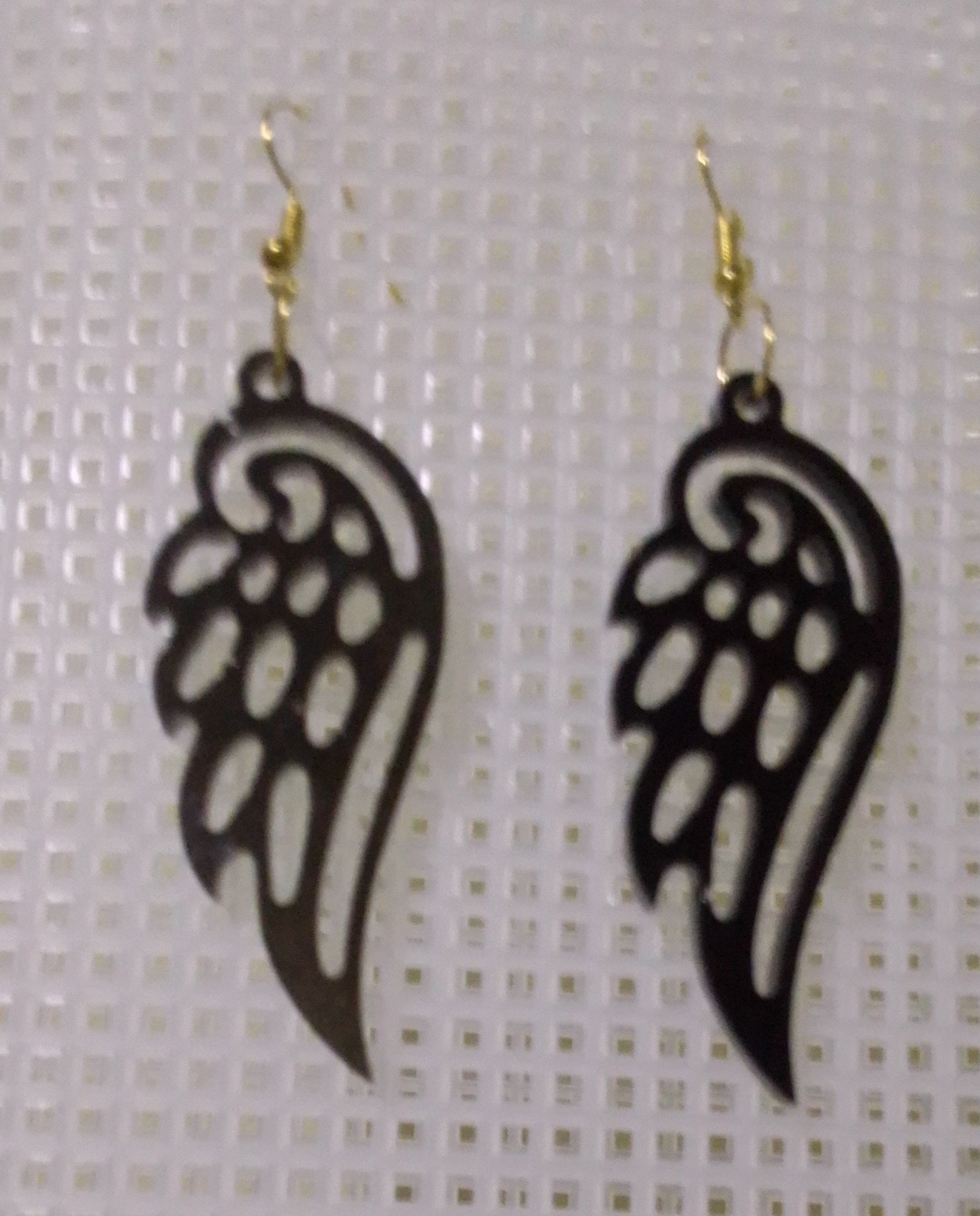 volcanic ash and epoxy resin earrings shaped like angel's wings