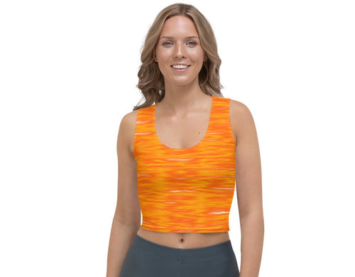 woman wearing a sleeveless crop top with a pumpkin spice design