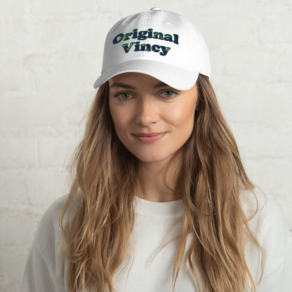 White dad hat with 'original vincy' written in camouflage green letters.