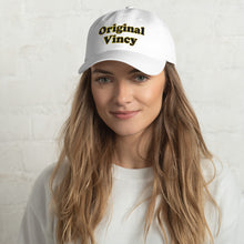 Load image into Gallery viewer, White dad hat with &#39;original vincy&#39; written in black and yellow letters.
