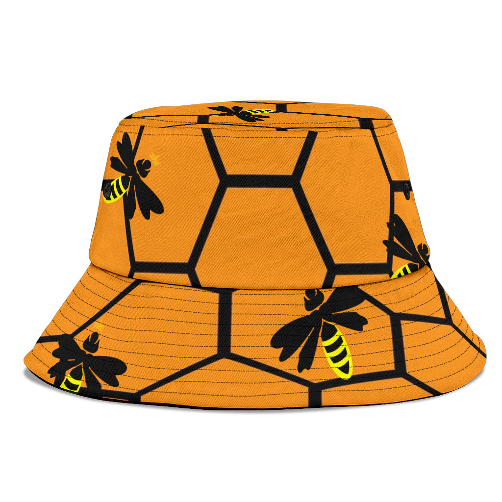 Amber-coloured bucket hat with honeycomb design and queen bees