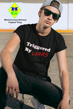 Load image into Gallery viewer, model wearing a black t-shirt with caption &#39;triggered by liars&#39; in black and red lettering
