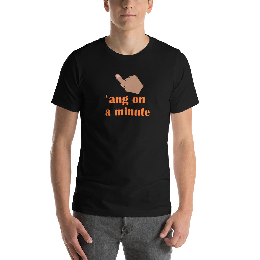model wearing a black t-shirt saying 'ang on a minute' in orange letters 