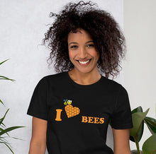 Load image into Gallery viewer, t-shirt showing a bee carrying a heart with the caption &#39;I love bees&#39;.
