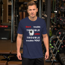 Load image into Gallery viewer, Navy t-shirt sporting the motto &#39;don&#39;t trouble trouble unless trouble troubles you&#39; in black and red letters and a hand holding a gun.
