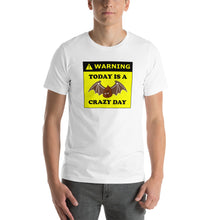 Load image into Gallery viewer, model wearing a t-shirt stating WARNING, today is a bat shit crazy day with &#39;bat shit&#39; represented by a poop illustration with bat wings.
