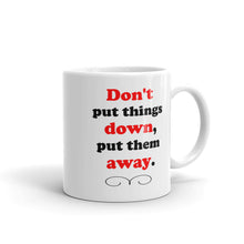 Load image into Gallery viewer, White ceramic glossy mug with the words &quot;Don&#39;t put things down, put them away&#39; printed in black and red letters.
